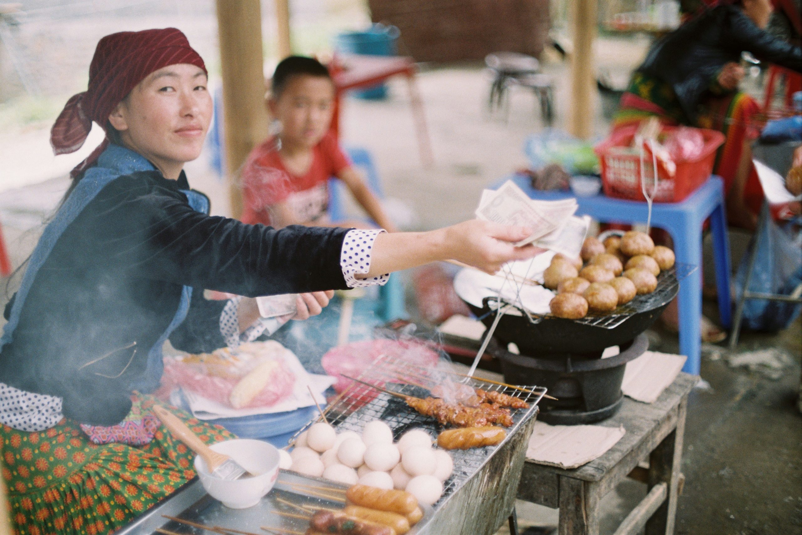 Vietnamese woman preparing street food at a local food stall in Northern Vietnam
