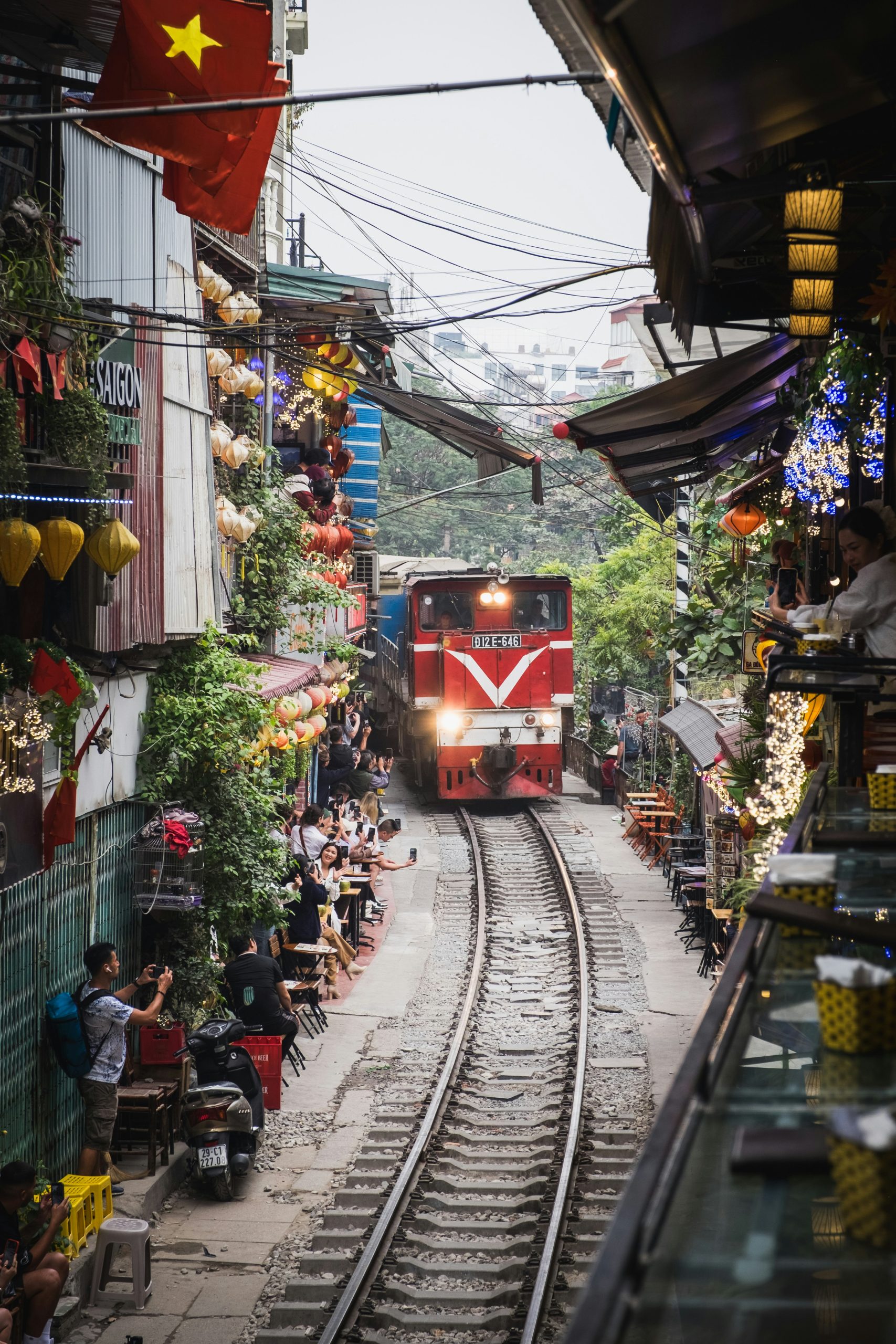 Hanoi Train Street surrounded by homes and local cafés in Vietnam