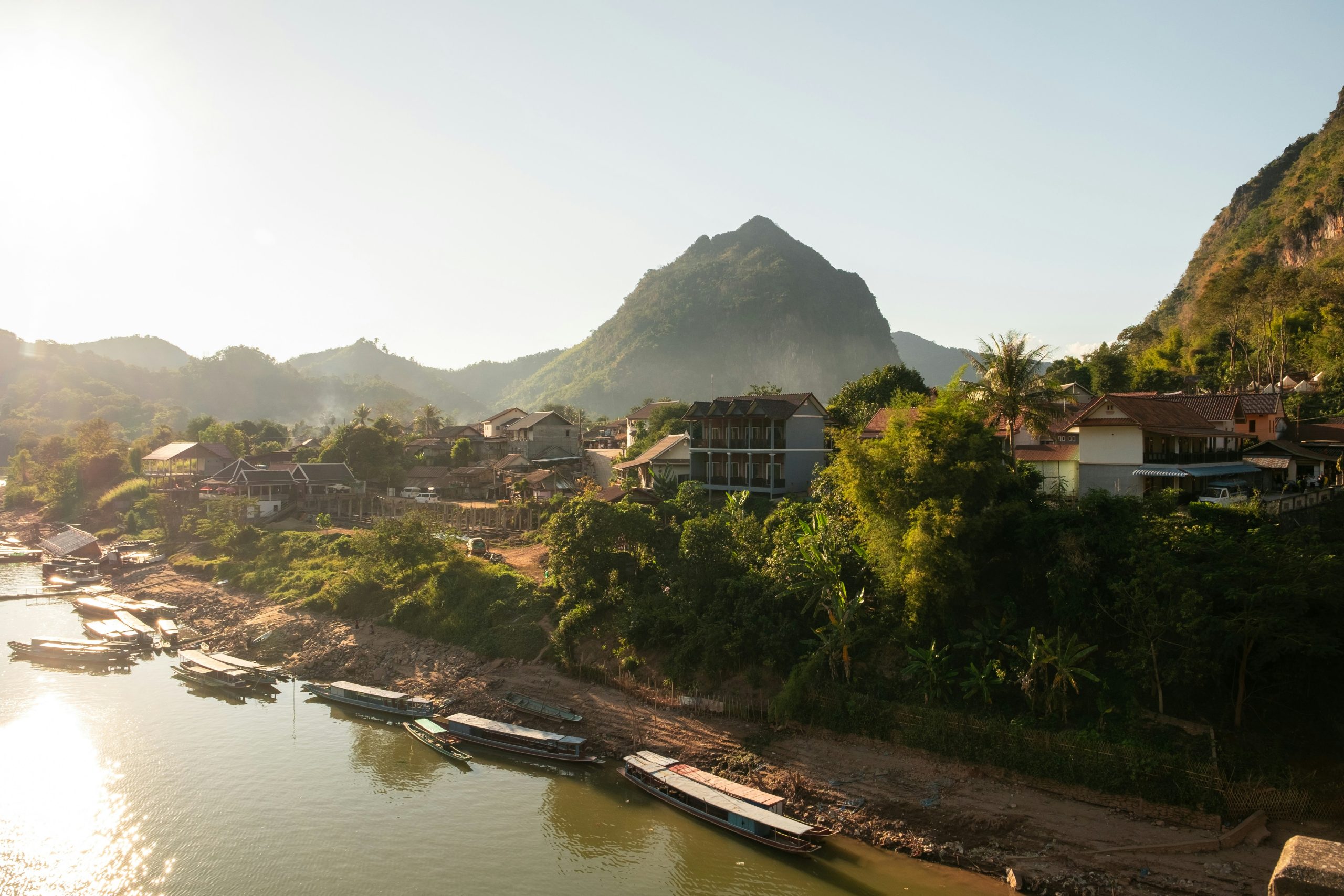 Traditional Lao village surrounded by lush countryside