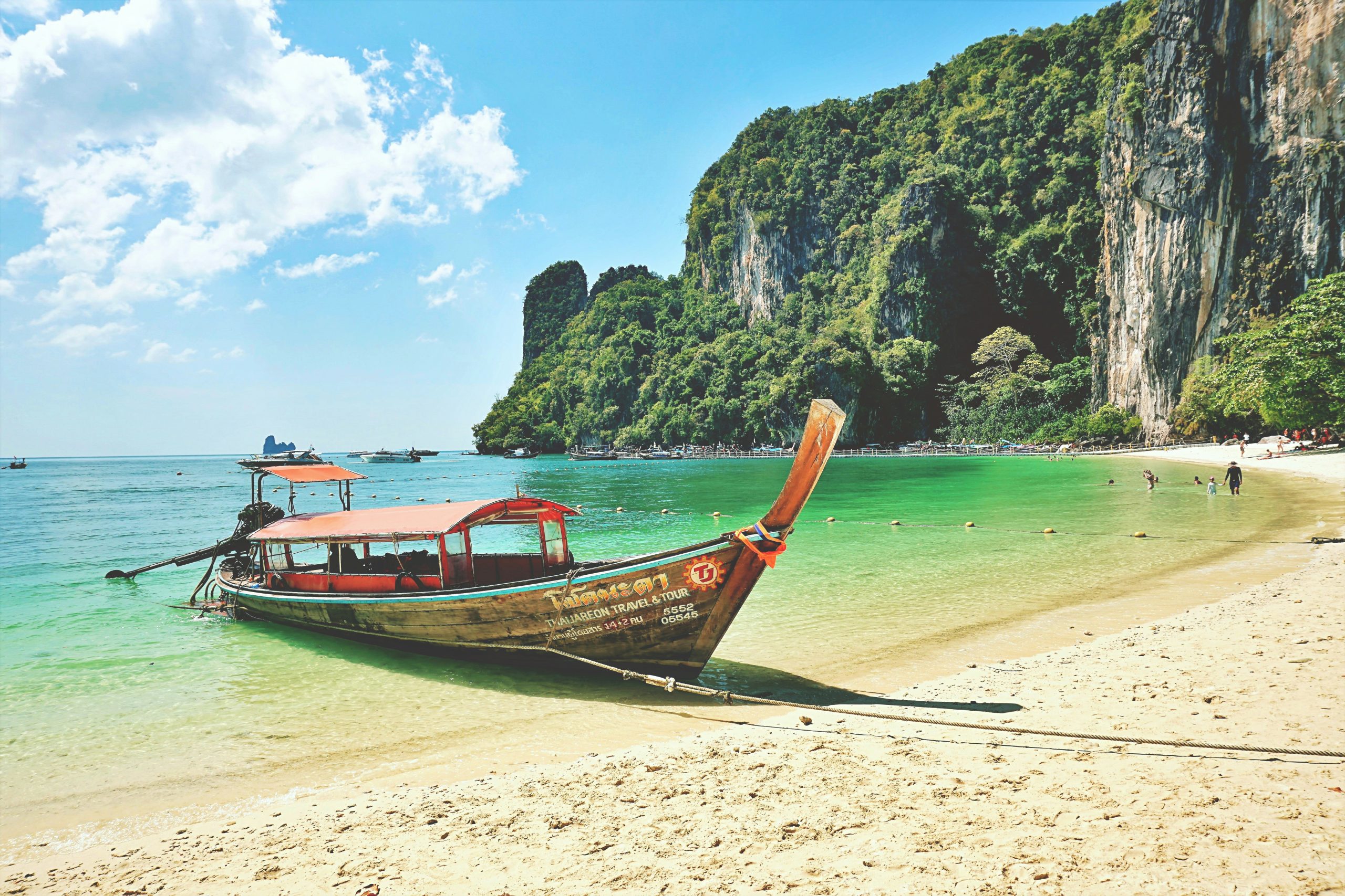 Traditional long-tail boat on a tropical beach in Thailand