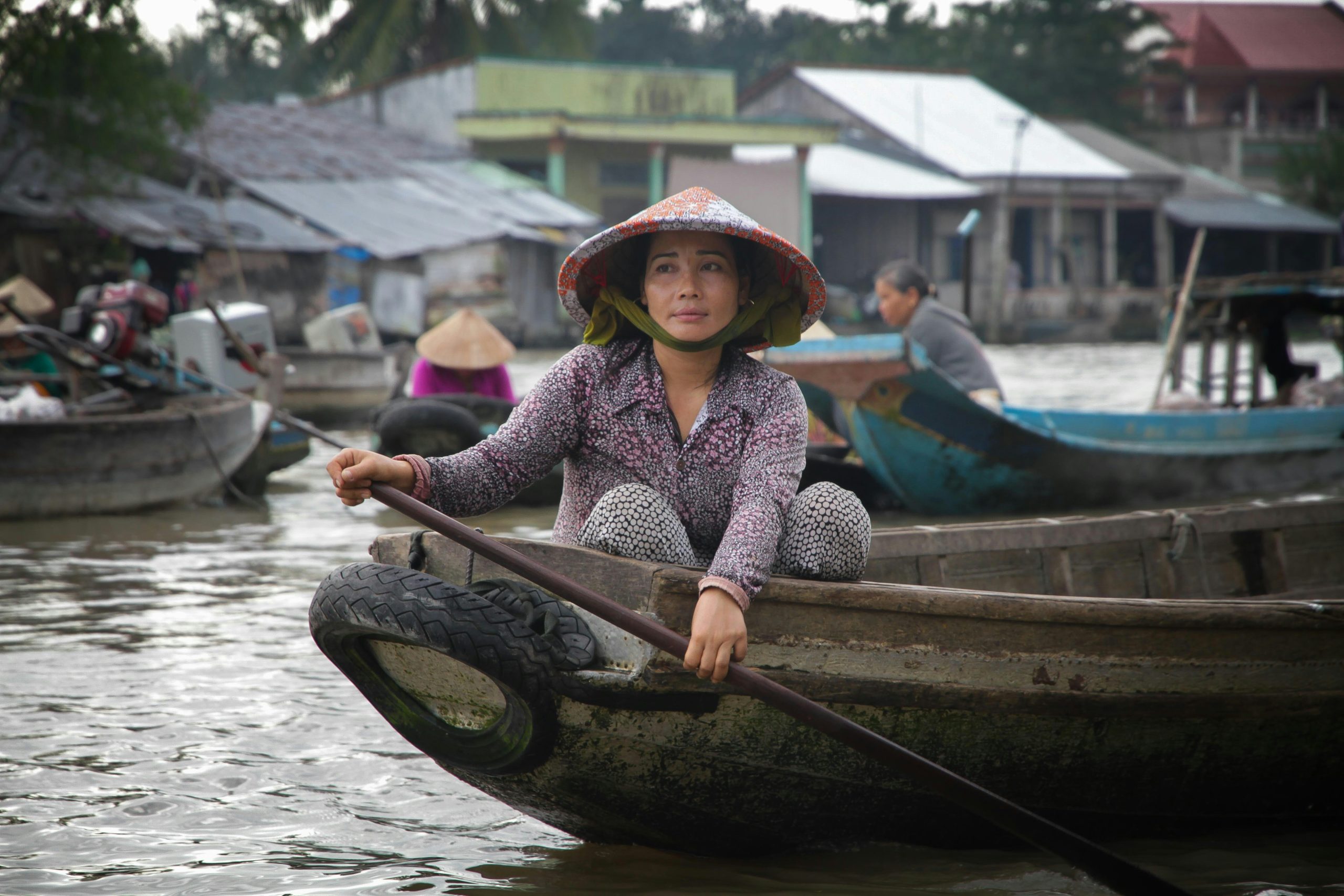 Local woman travelling by boat on the Mekong Delta, Vietnam