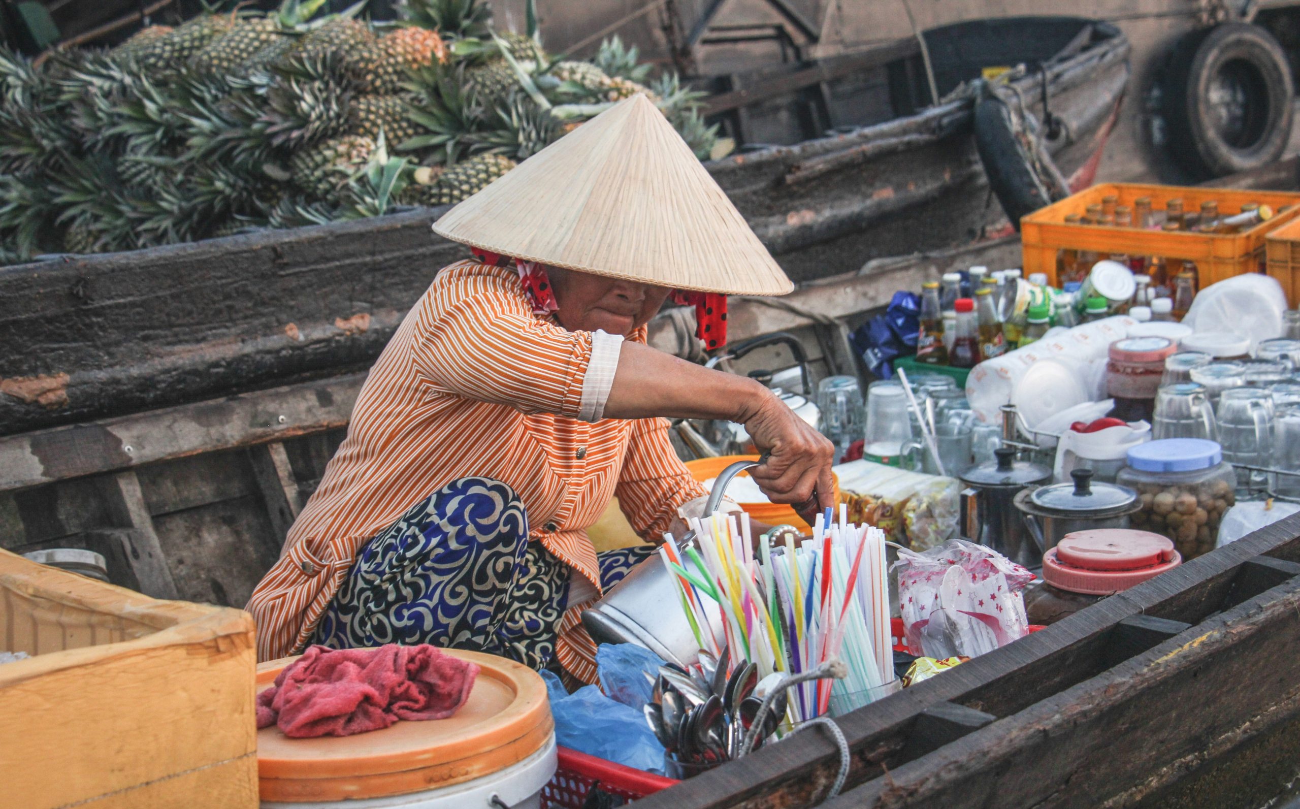 Woman preparing coffee on a boat in the Mekong Delta, Vietnam
