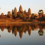 Angkor Wat temple reflected in the water at sunset in Cambodia