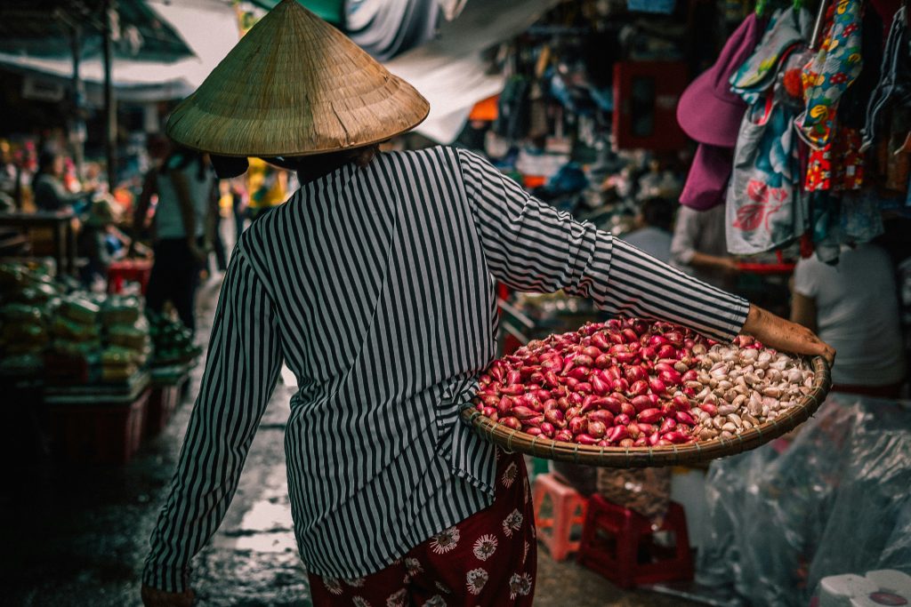 Local Vietnamese woman walking to a market with a basket